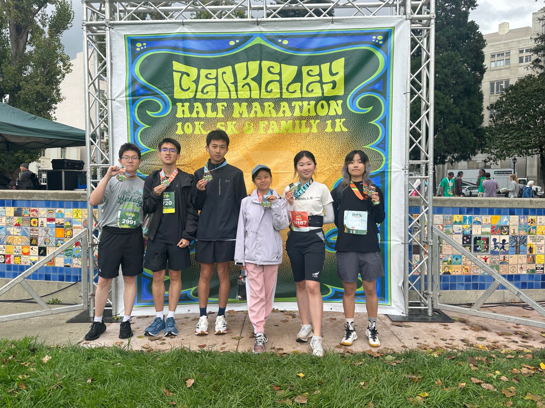 Six Keep Running Club members with finisher medals at the Berkeley Half Marathon