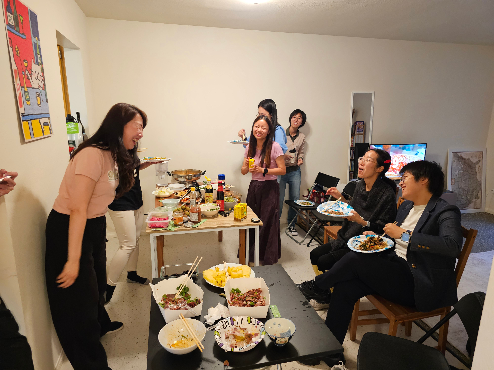 Members sharing hotpot and zongzi in a warm living room