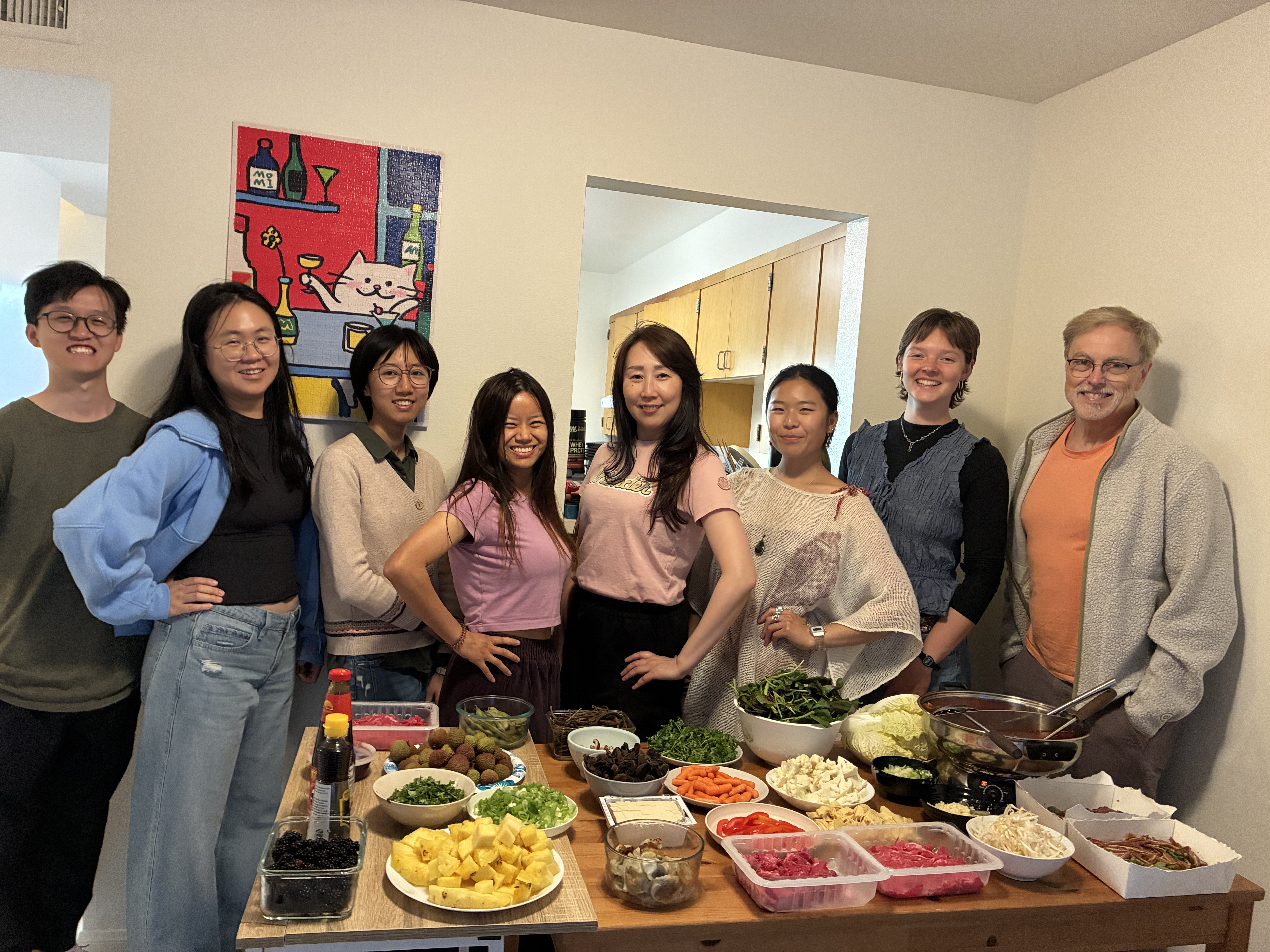 Members gathered around a hotpot table laughing on Dragon Boat Festival